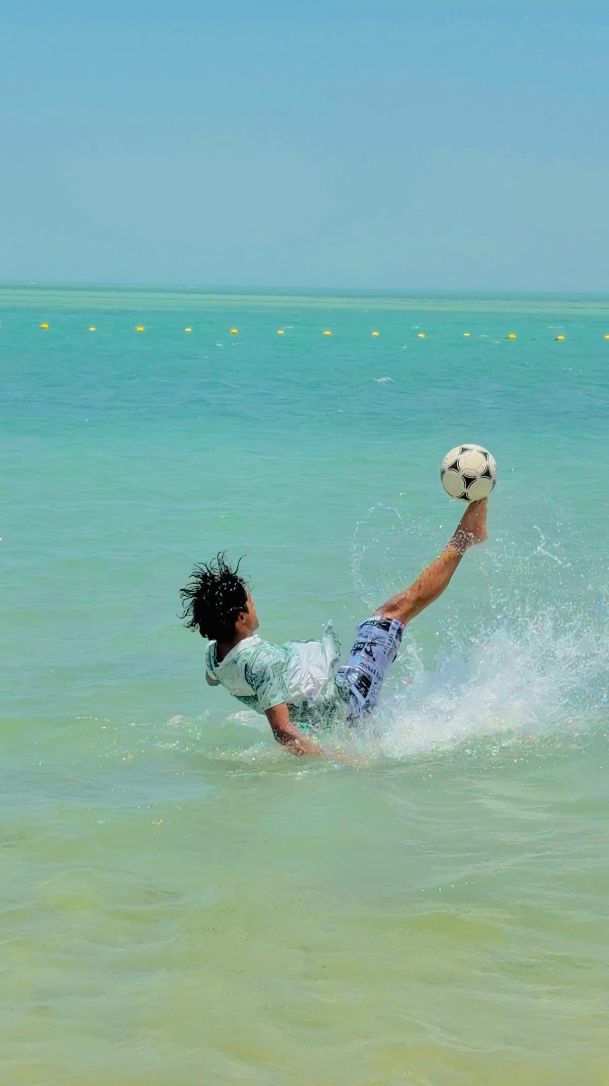 Sinan Basim mid bicycle-kick in the sea