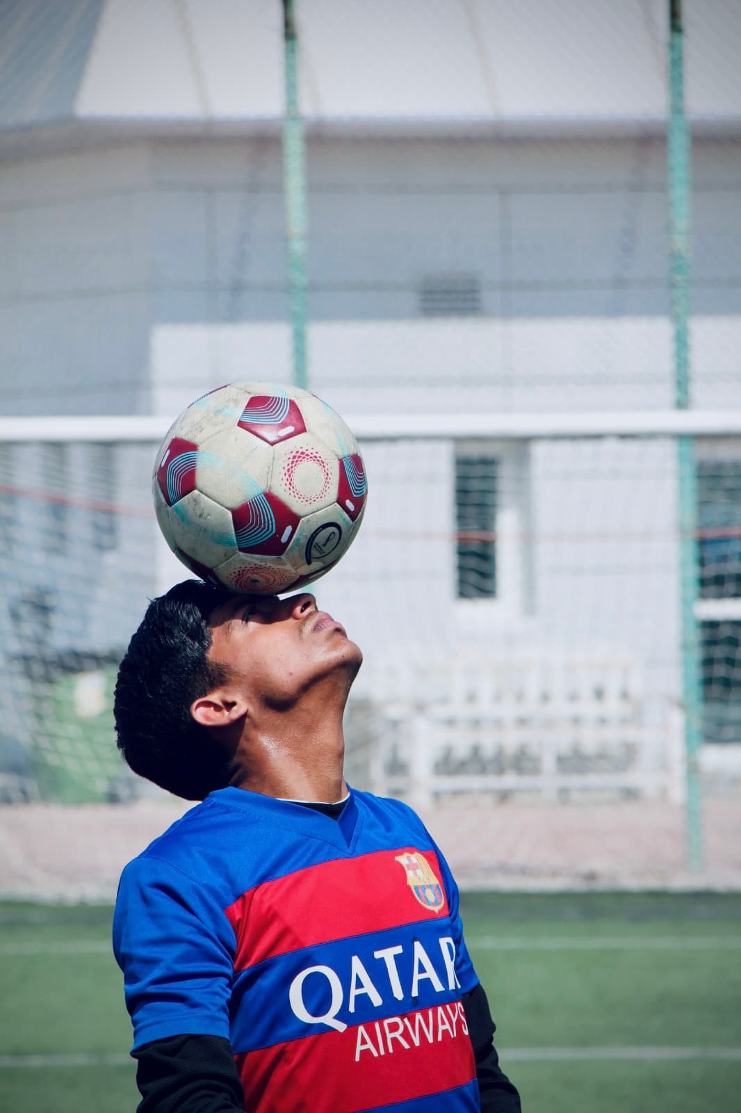 Ball balance on the face wearing a Barça jersey